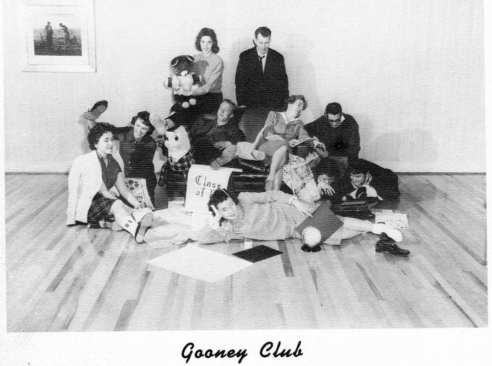 High schoolers sprawled out and collapsed around a chair, with the caption "gooney club"