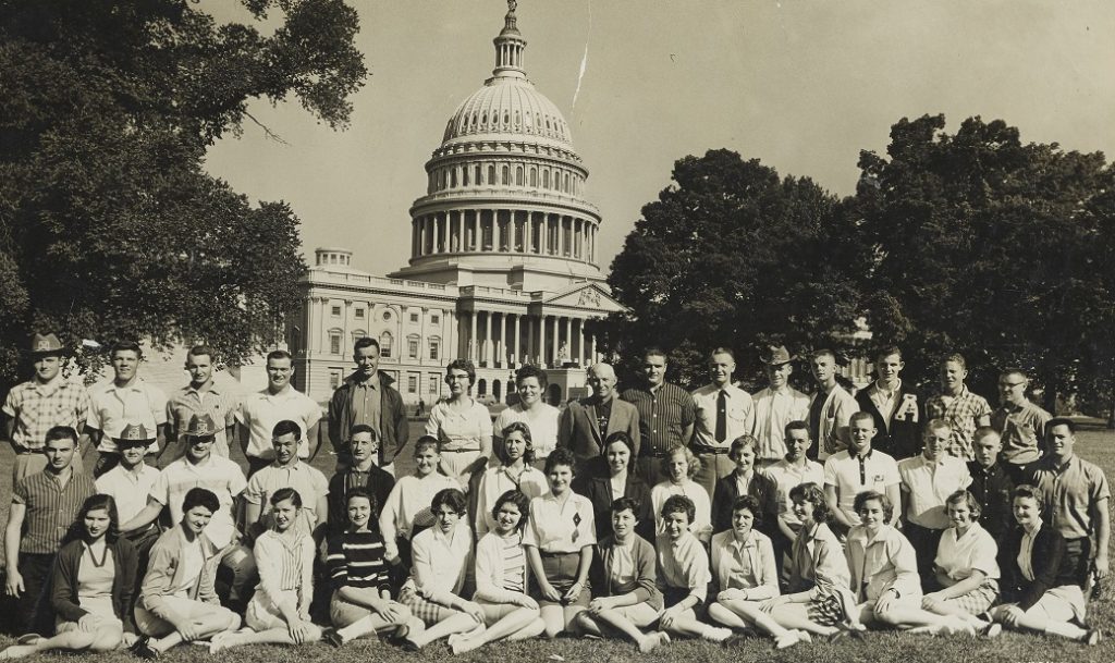 students and chaperones in a group photo with the US Capitol in the background