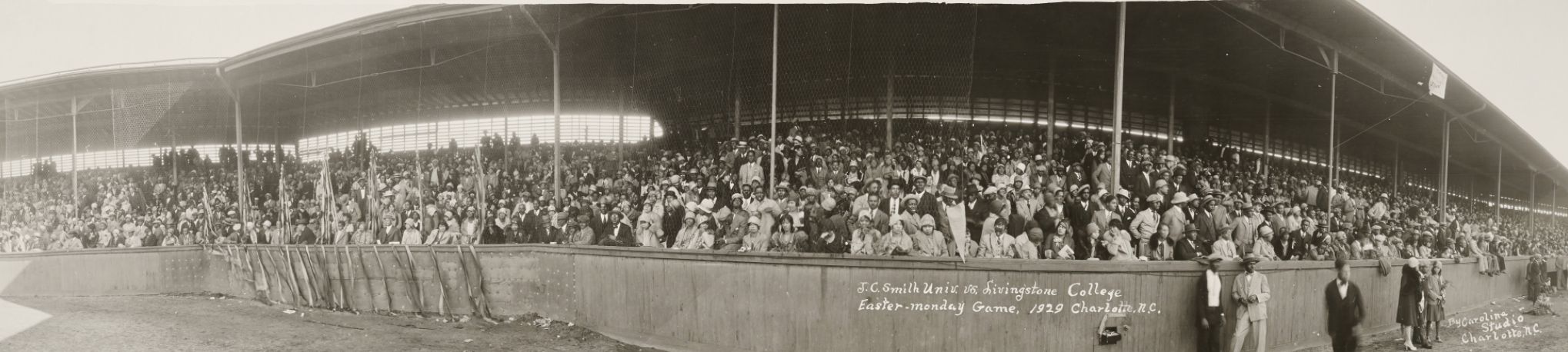 Panoramic photo of the crowd watching a baseball game from the stands. 