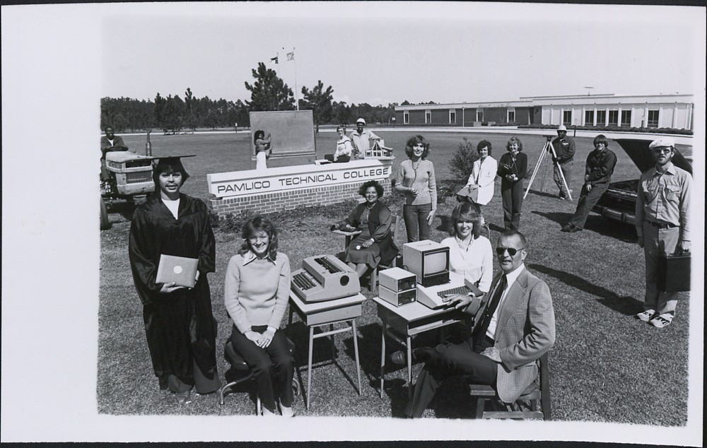 Students and faculty standing on the lawn at the new Pamlico Technical College building representing various areas of study. 
