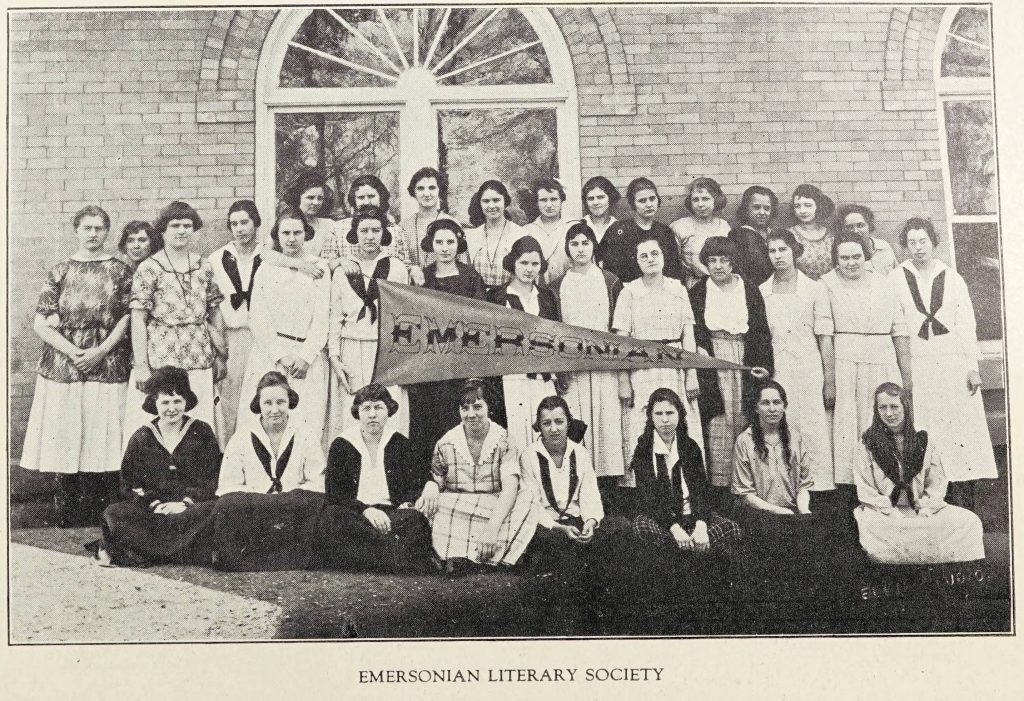 Black and white group portrait of high school students holding a pennant that reads Emersonian