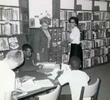 Mollie Huston Lee looks around the Richard B. Harrison Library on New Bern Ave.