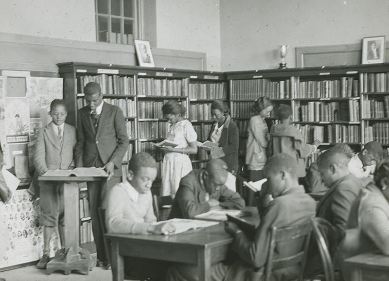 Library Scene African-American High School Age Students Reading Standing or Seated