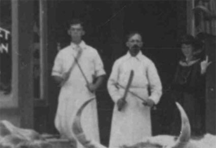 Close up of two butchers from the image of City Market from the Transylvania County Library