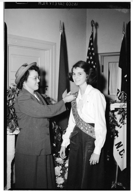 Image of a Girl Scout receiving a badge