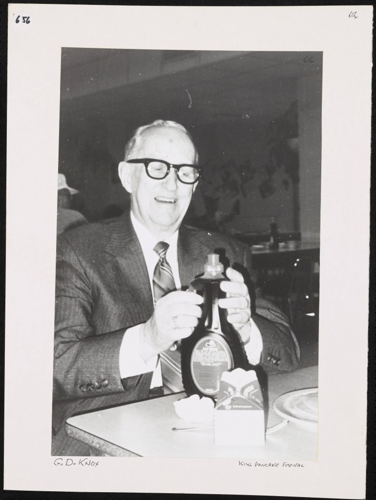 Man holding syrup bottle