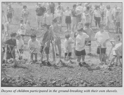 Ground is broken for the Shalom Park Expansion in April 2002 with families from the community participating.