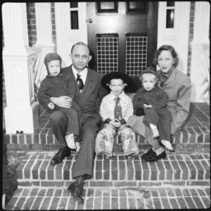 family_poses_for_christmas_picture_on_steps