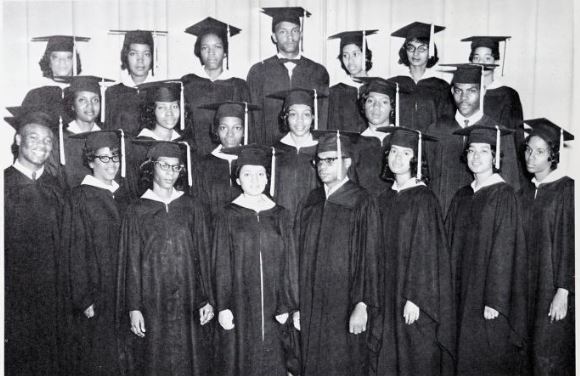 Class of 1963 in caps and gowns.