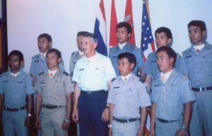 Ten individuals in uniform standing in a group facing forward