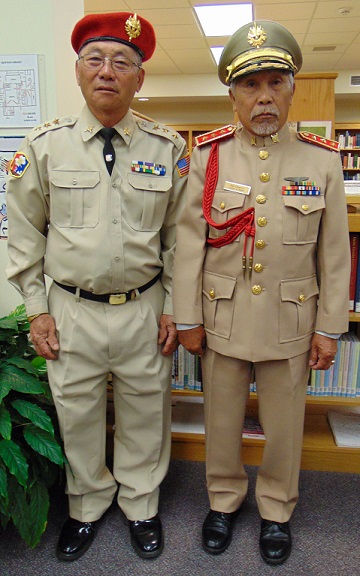 two individuals in military uniform looking at the camera