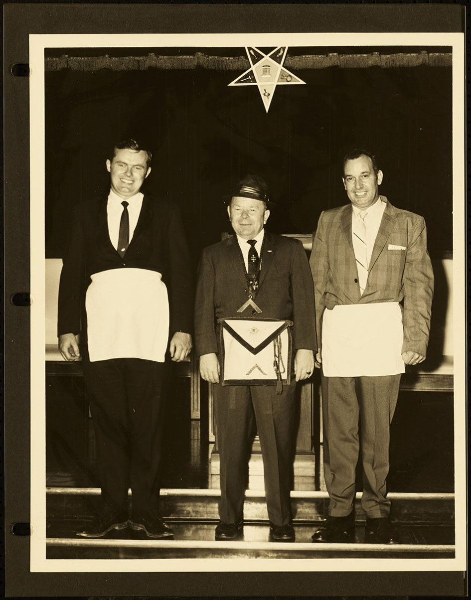 Three men posing for a picture,