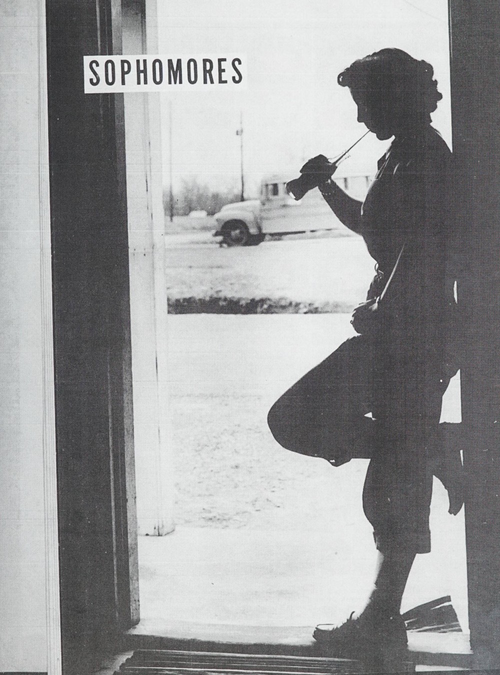 Person standing in a doorway drinking from a glass Coke bottle with a straw. "Sophomores" is written in the top left.