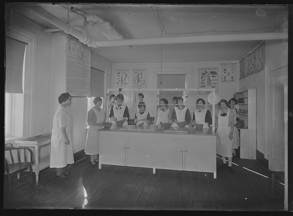 Group of students standing in a kitchen classroom space 