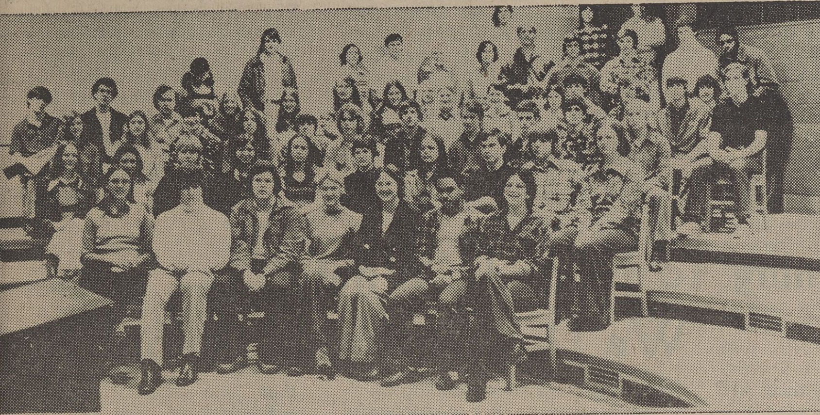 A group of band students sitting on risers.