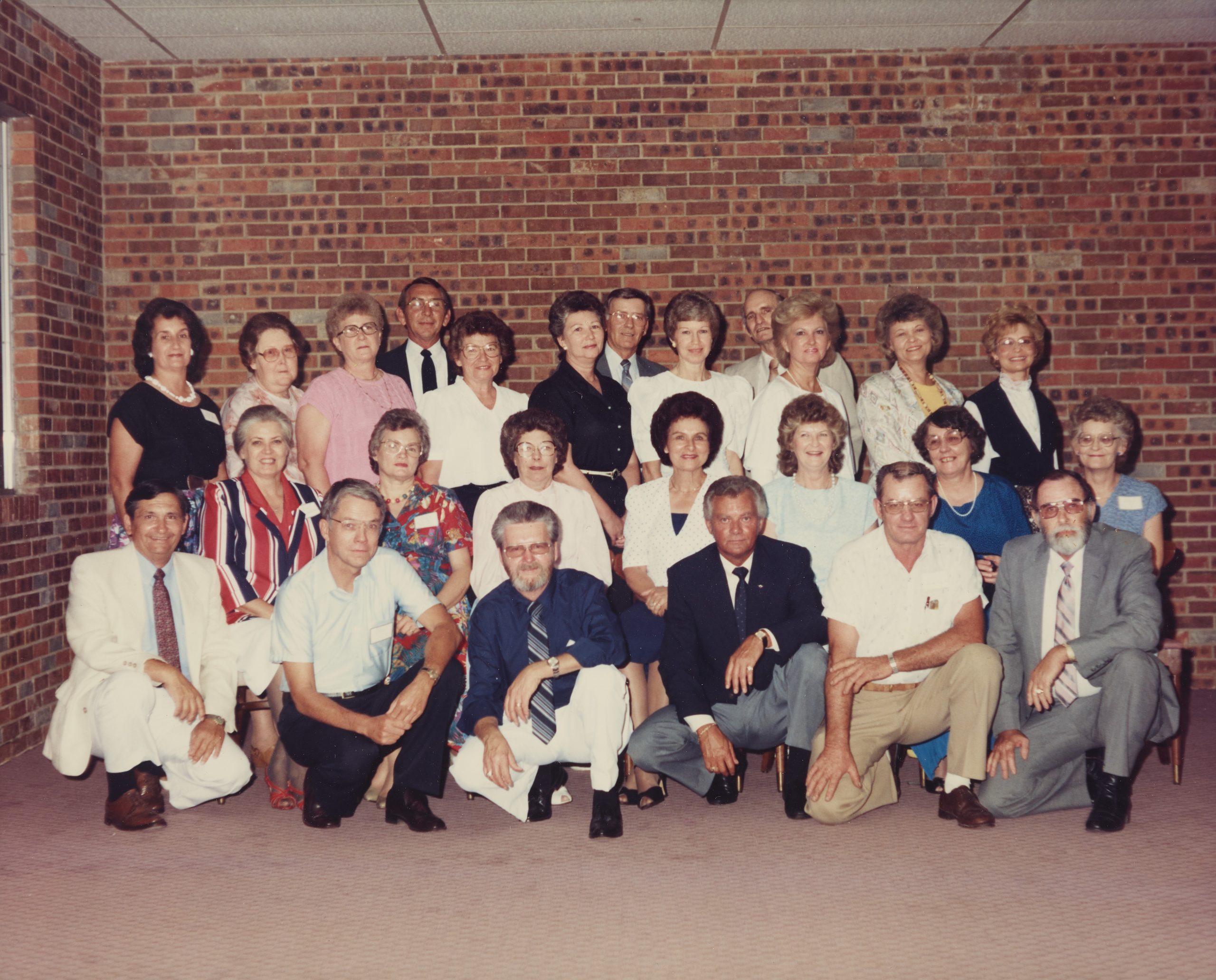 A large group of adults posing for a photograph.