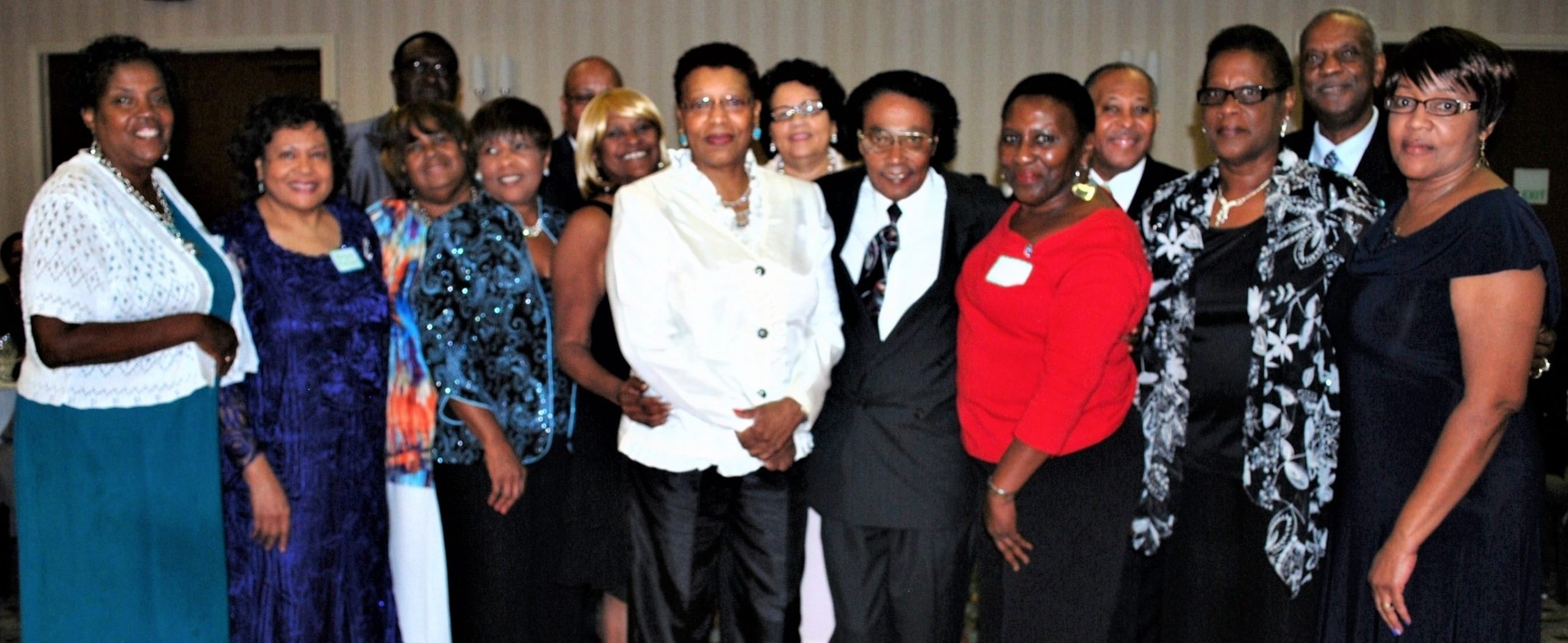 Photograph of a group of African American individuals who are dressed formally. 