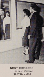 Photo of two teenagers standing beside each other and looking into a mirror