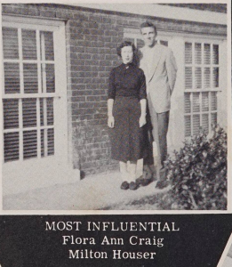 Two students standing together in front of a brick building