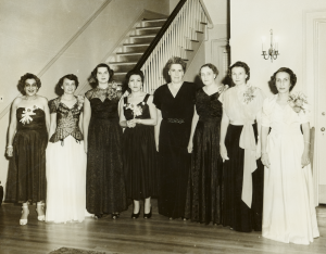 A black-and-white photo of a group of white women in formal wear