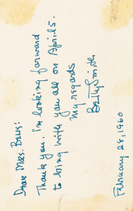 The back of the postcard with a message written in blue pen.