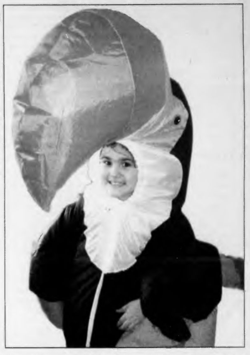 Small child dressed as a bird with a large beak. It appears that the beak and body is inflated by an internal fan.