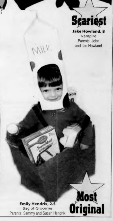 Child with a milk container on their head with an oval cut out for their face. They are wearing a bag-like top with an opening that is holding a box of Betty Crocker cake mix and an egg carton.