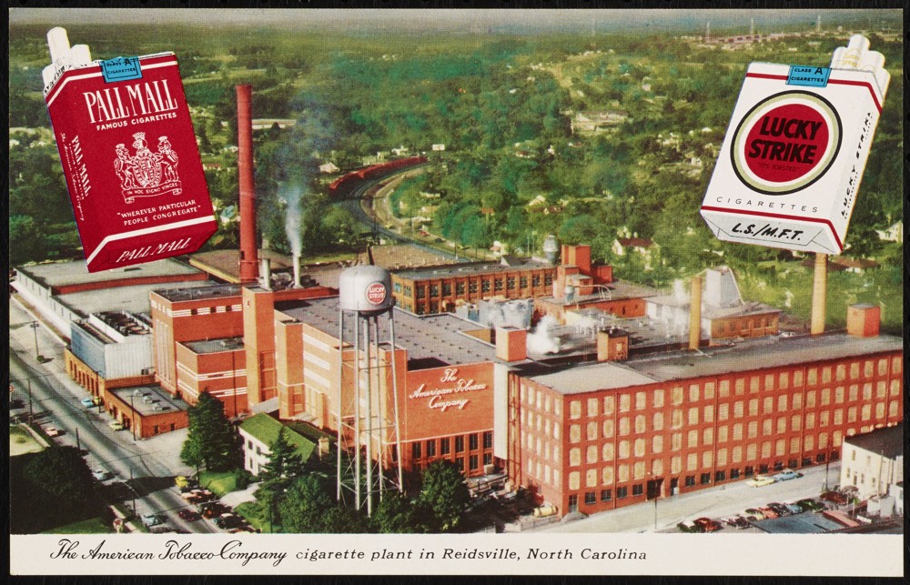 A postcard depicting the American Tobacco Company factory in Reidsville. In the top two corners are enlarged packets of Pall Mall and Lucky Strike cigarettes.