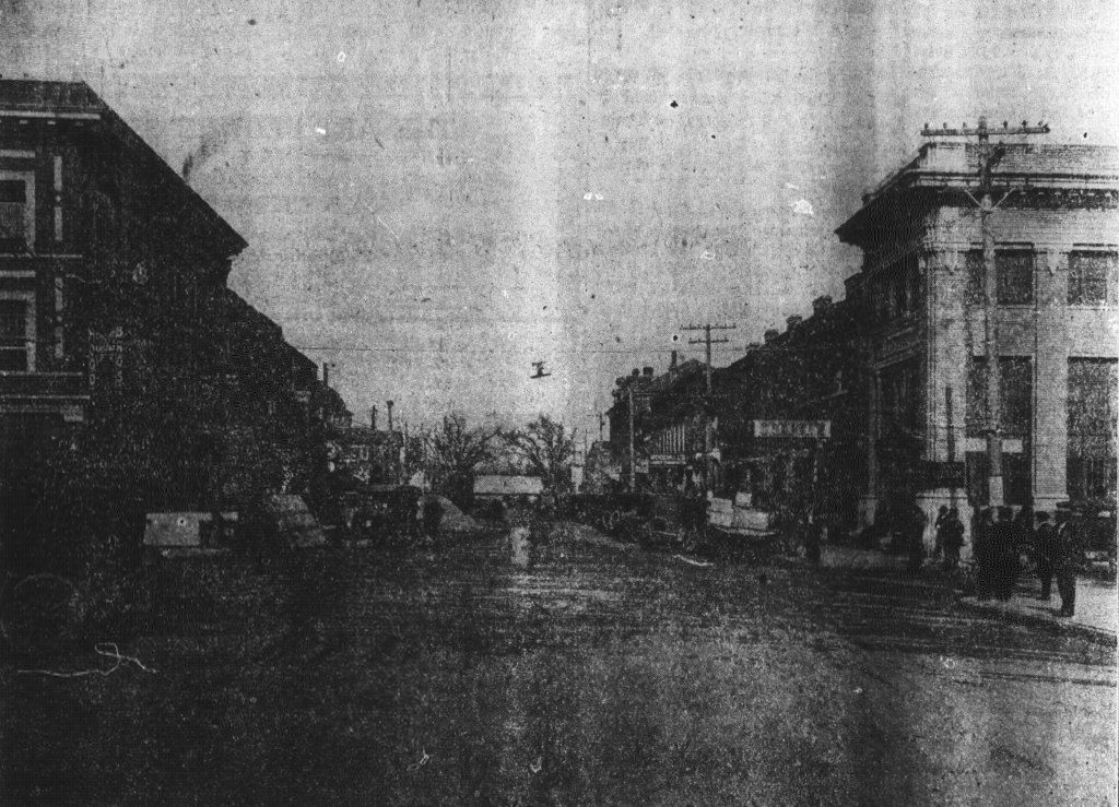 A black-and-white photo of a nearly empty street in Smithfield. The image is blurry, so only the large buildings on either side are clear.