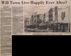 A newspaper clipping with a photo of a downtown street of Roanoke Rapids.