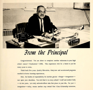 A page from a yearbook showing a black-and-white photo of a principal sitting at a desk. Below is a typed message.