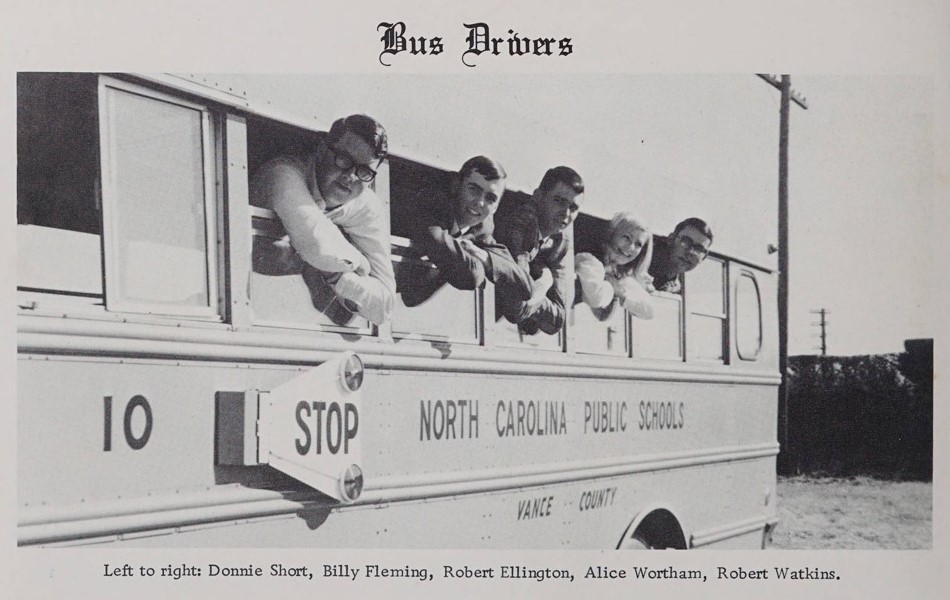 Five people hanging out the windows of a school bus with the caption "Bus Drivers"