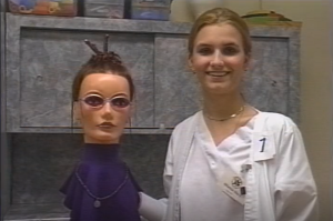 Individual posed with a mannequin with styled hair.