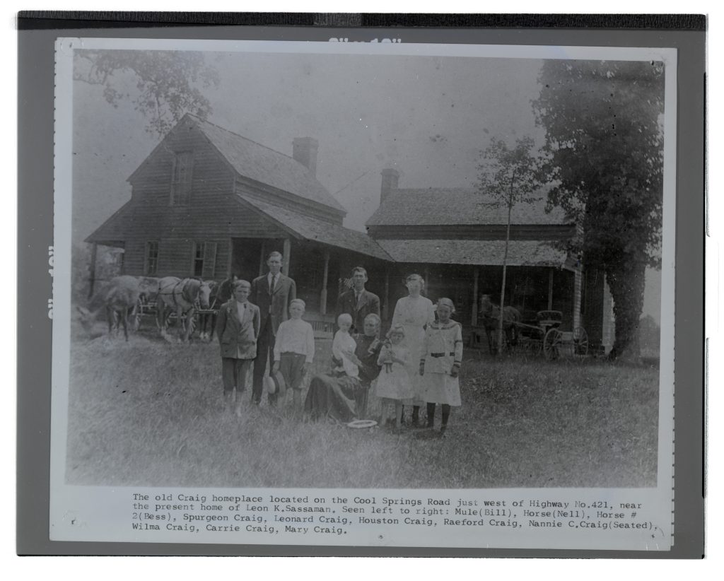 A black-and-white photograph of the Craig family in front of their home. Bill the mule and Nell the horse are also pictured.