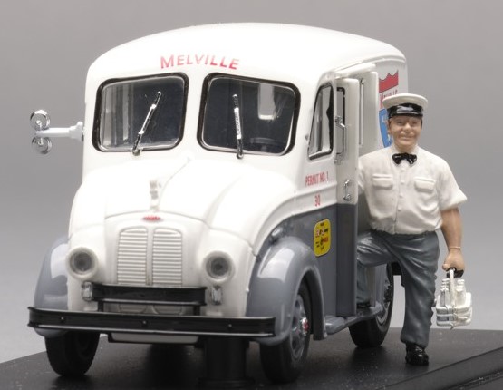 3D object. Delivery truck with a person dressed in a delivery outfit holding a tray holding milk bottles. 