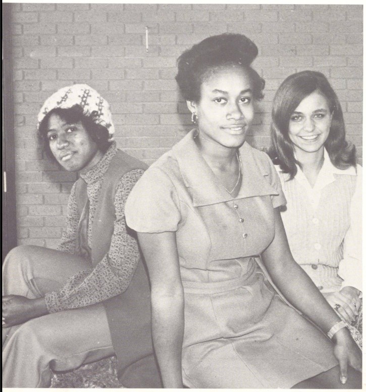 Three individuals sitting next to each other.