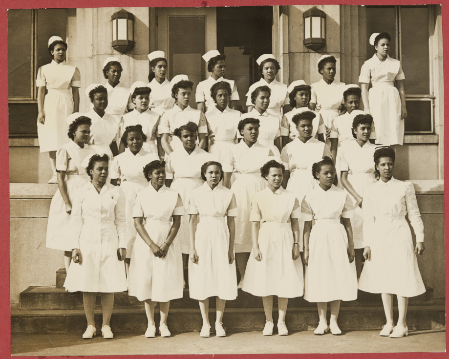A group of nurses pose on the front steps of Kate Bitting Reynolds Memorial Hospital (Winston-Salem, N.C.).