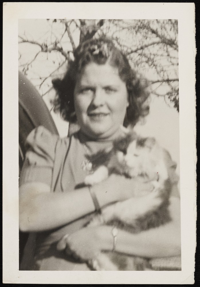 Adult holding a cat.