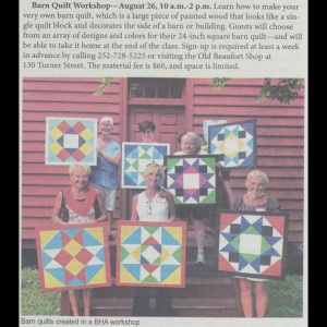 A newspaper excerpt with a short description of the workshop and a photo. Photo shows seven people holding up their barn quilts in front of a building with red panelling and a red door. The barn quilts are all geometric patterns made from triangles and squares with bright colors.