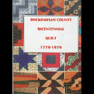 The cover of the program which has a quilt in the background. The quilt squares are varied, though mostly in earthy red, blue, and green tones. The squares feature mostly geometric, symmetrical patterns. In front is the heading of the program in red font with a white background: “Rockingham County Bicentennial Quilt 1776-1976”