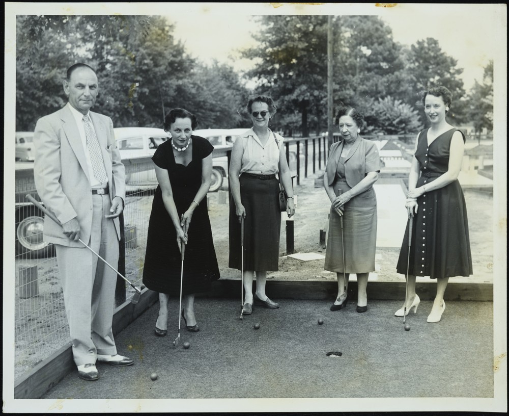 Group of adults playing mini golf