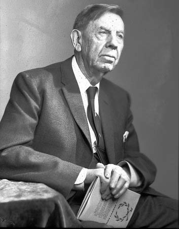 A black-and-white photograph of James Pearson sitting in a suit.