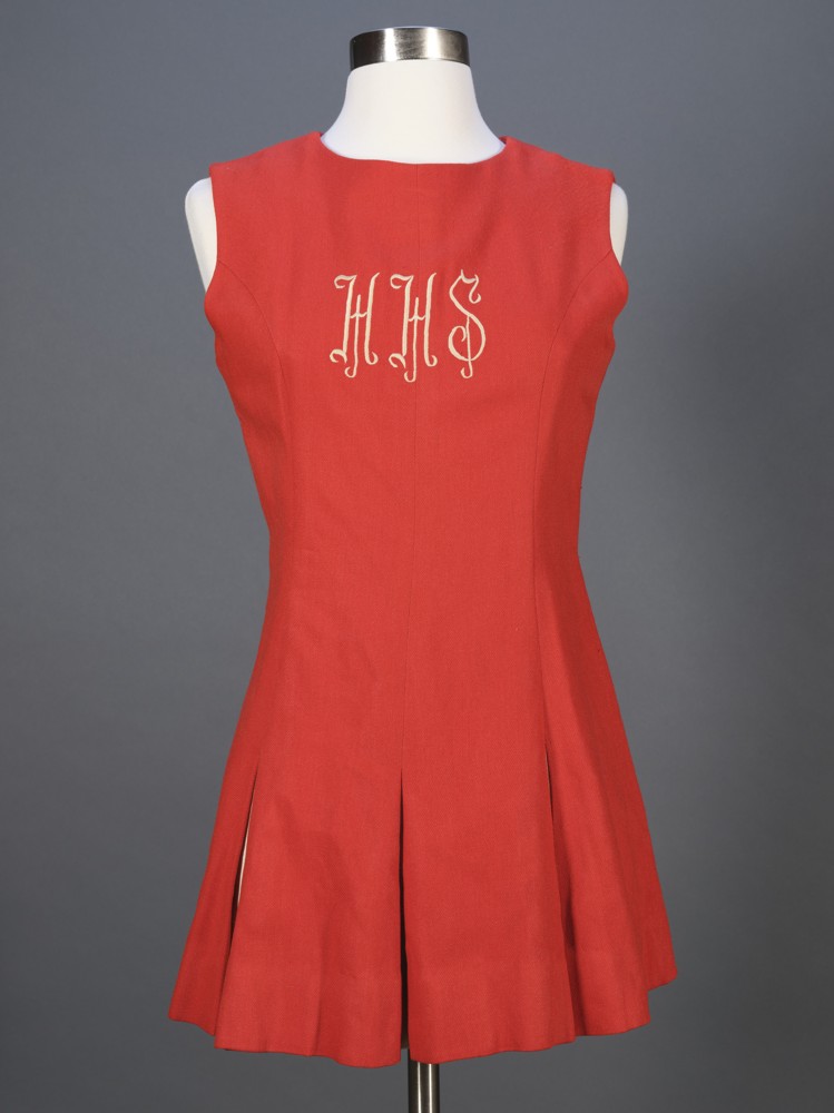 A red cheerleading outfit with the letters H. H. S. on the chest in white.