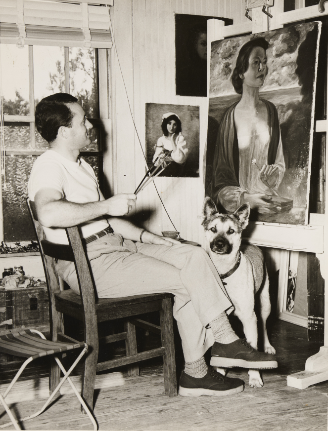 Unidentified painter with his dog and several artworks.