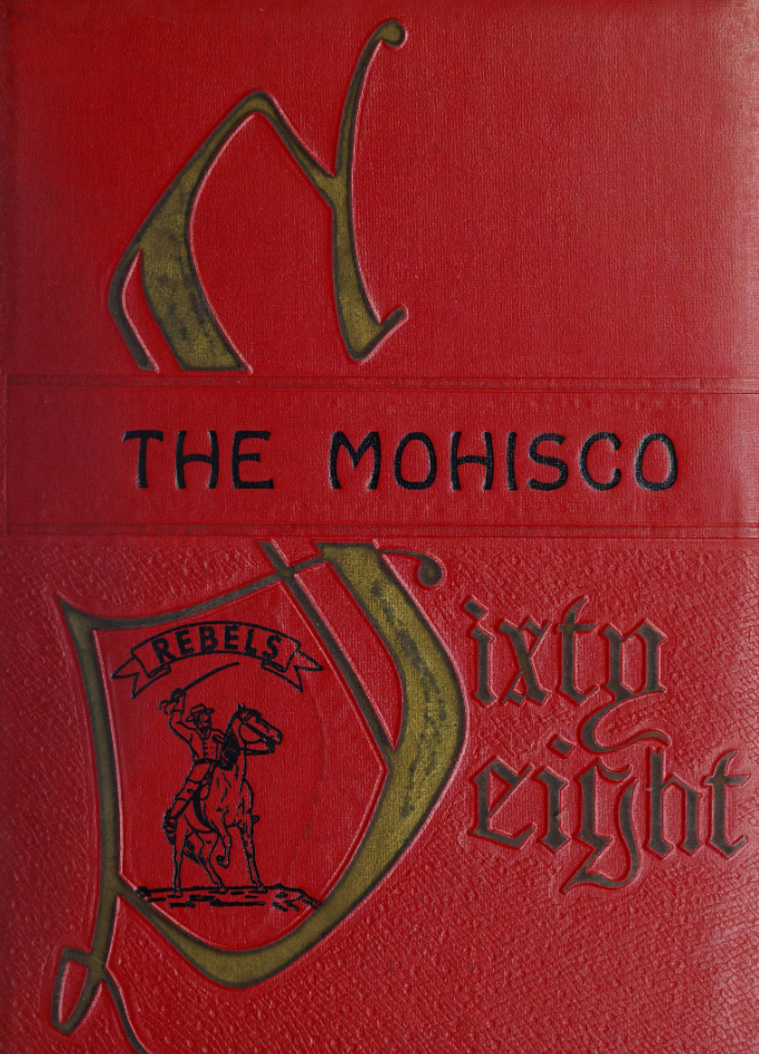 The cover of The Mohisco [1968]. The yearbook cover is a carmelian red color with the title "The Mohisco" printed in black across the middle. A decorative golden "S" takes up the entire left hand side of the page as part of the date "Sixty eight" which takes up the lower right hand side of the cover. Inside the "S", an illustration of a sword-wielding person on horseback is printed below a banner that says "REBELS".