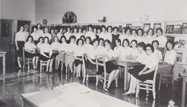 The 1963-1964 Future Homemakers of America. There are two rows, with the back row standing and the front row sitting at desks.