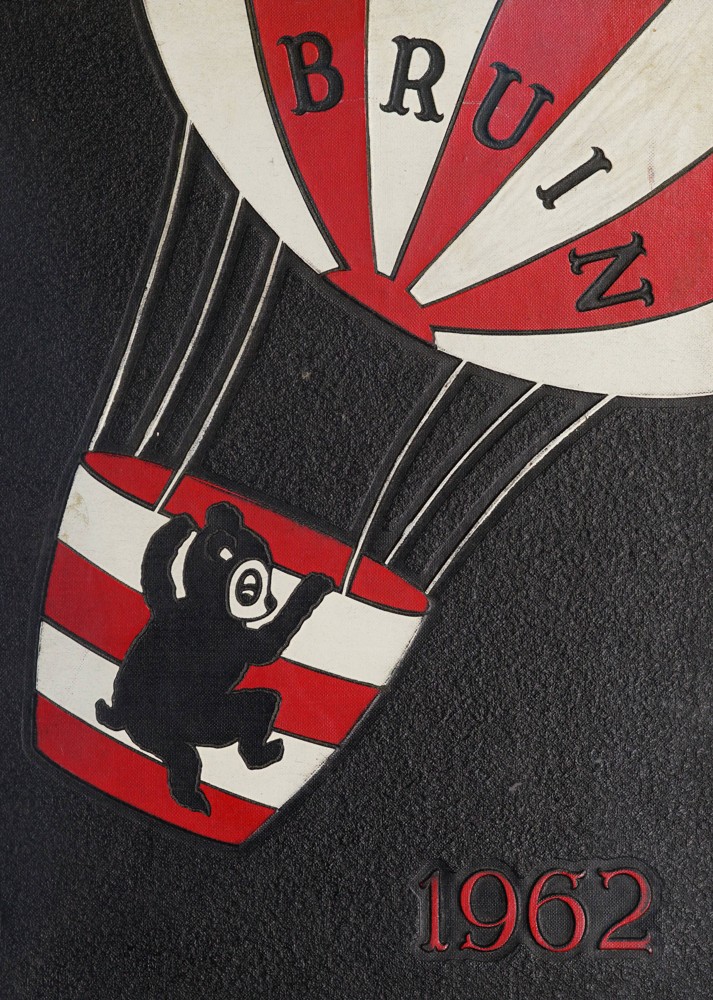 A dark gray cover with a red and white striped hot air balloon. The word "Bruin" is written on the balloon part with the date "1962" stamped on the bottom right of the cover in red ink. A small black and white bruin is climbing into the basket part of the hot air balloon.