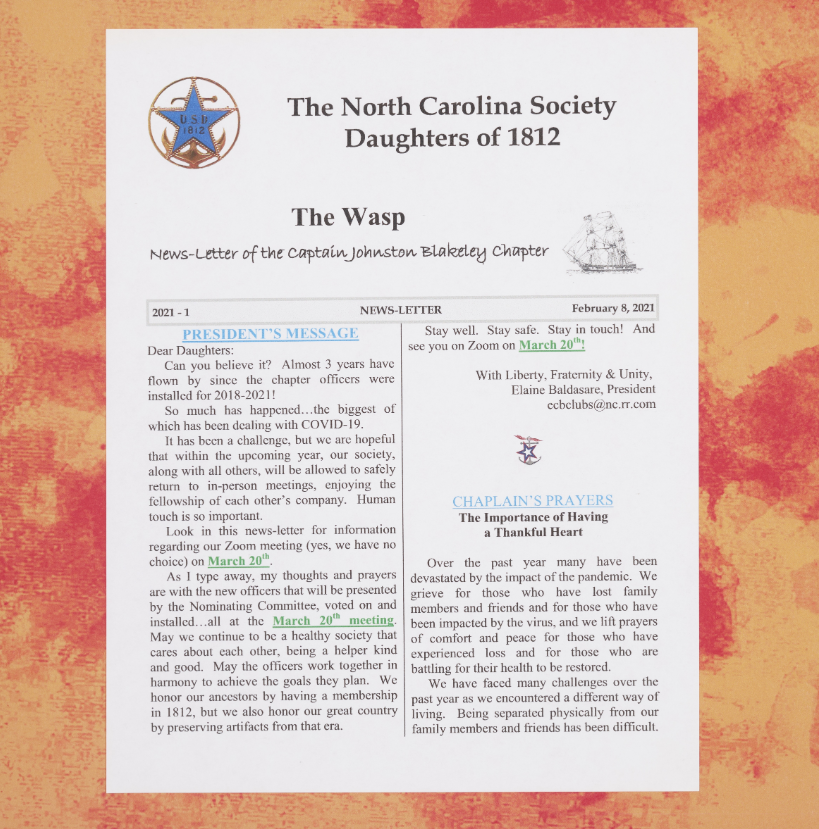 A page from North Carolina Society Daughters of 1812 Scrapbook [2019-2020] that includes the front page of The Wasp newsletter pasted onto an orange tie-dye background.